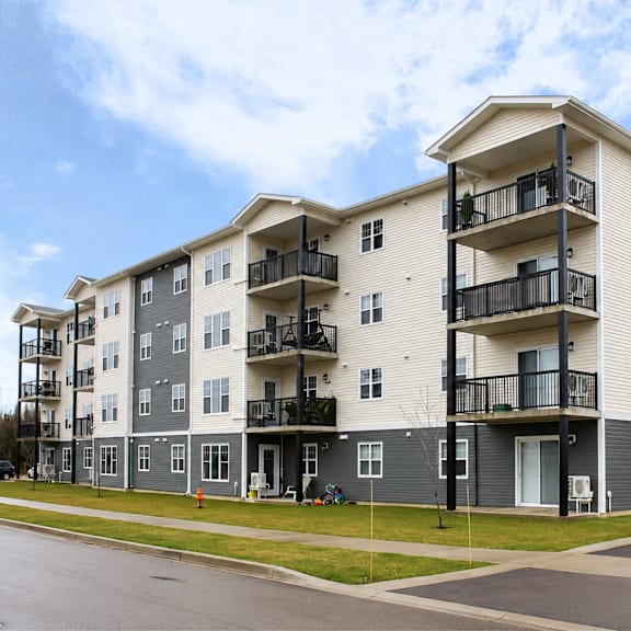 apartment building with balconies and doors.