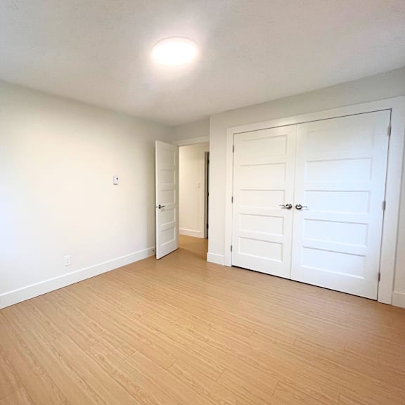 a room with a white door and a white wall.