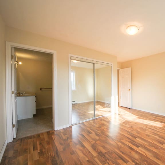 a room with wooden floors and a white door.
