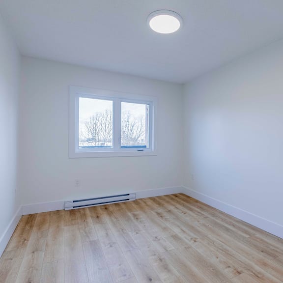 a room with a window and a radiator on the floor.