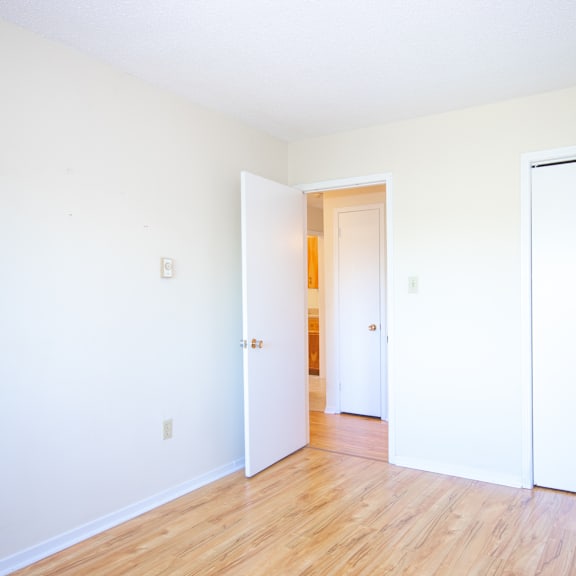 a room with a white door and a white wall.