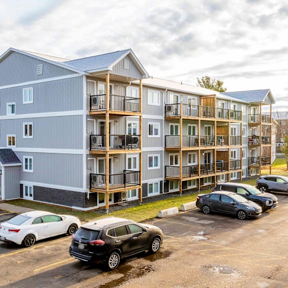 a large building with a parking lot in front of it.