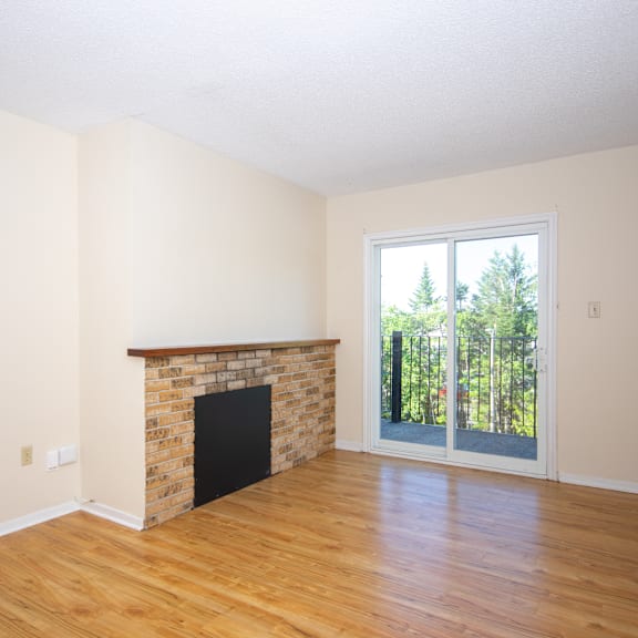 a room with a fireplace and sliding glass doors.