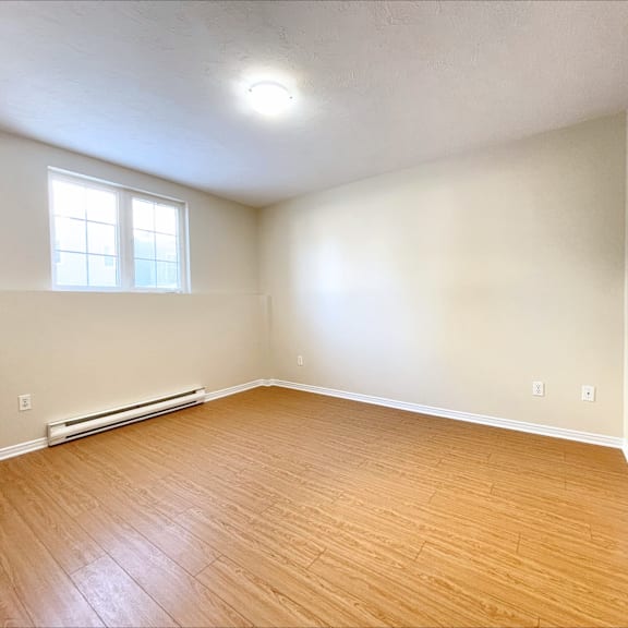 a room with a window and a radiator on the wall.