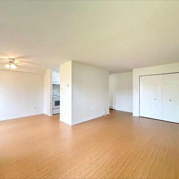 a room with wooden floors and a ceiling fan.
