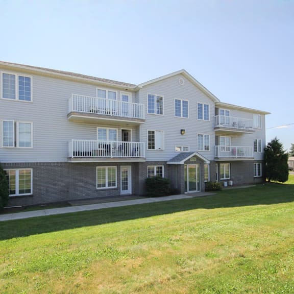 a large two-story apartment building with a balcony on the second floor.