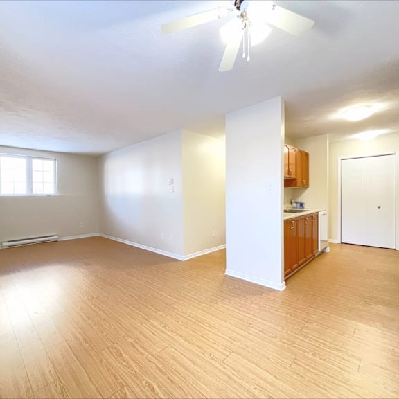 a room with wooden floors and a ceiling fan.