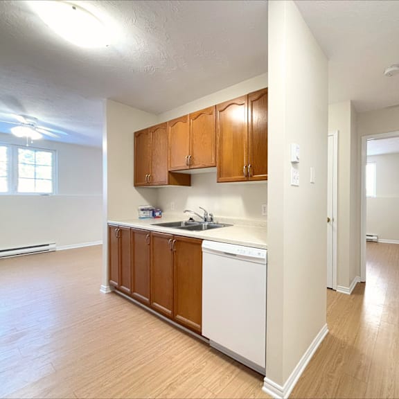 a kitchen with wooden cabinets and white appliances.