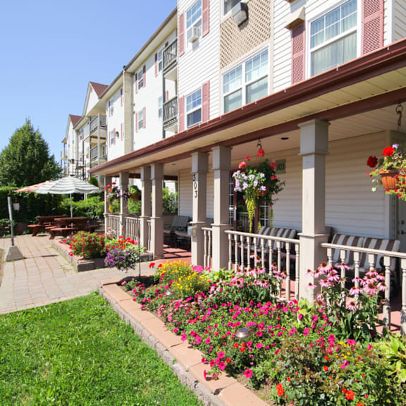 a building with a flower garden in front.