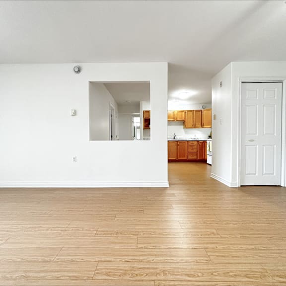 a room with wooden floors and white walls.