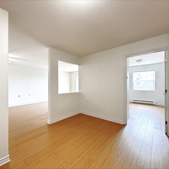 empty room with wooden floors and white walls.