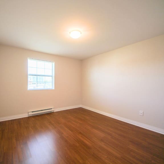 a room with a window and a radiator on the floor.
