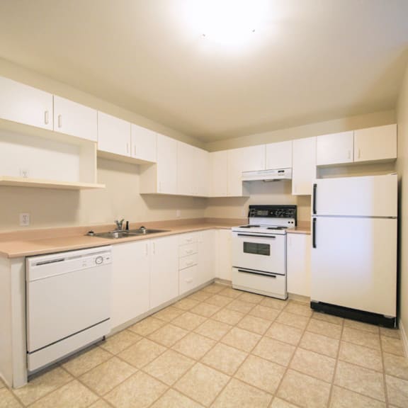 a kitchen with white appliances and cabinets.