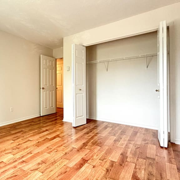 a room with a wooden floor and a white door.