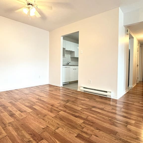 a room with wooden flooring and a ceiling fan.