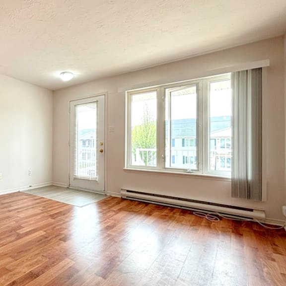 a room with wooden floors and white walls.