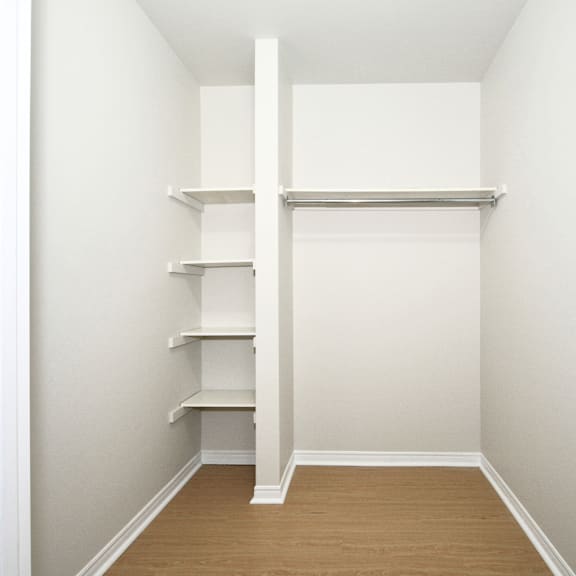 a white shelving unit in a room with white walls.