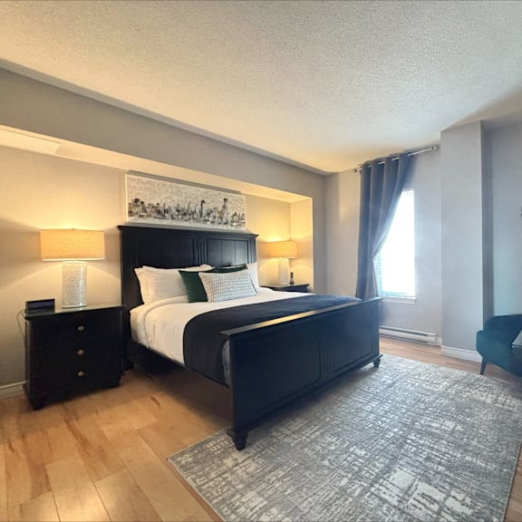 a bedroom with a large bed and a painting above it.