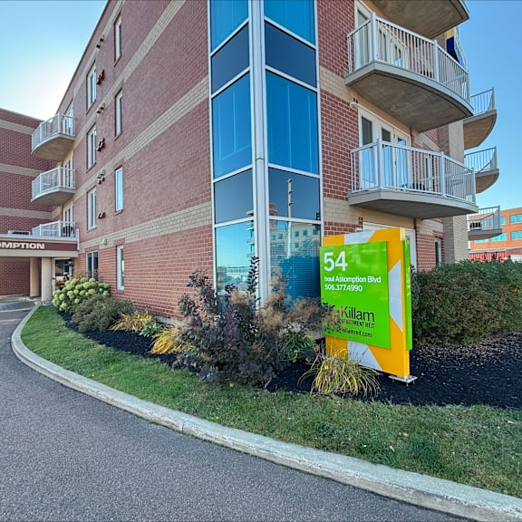 a building with a sign that says 54 assomption.