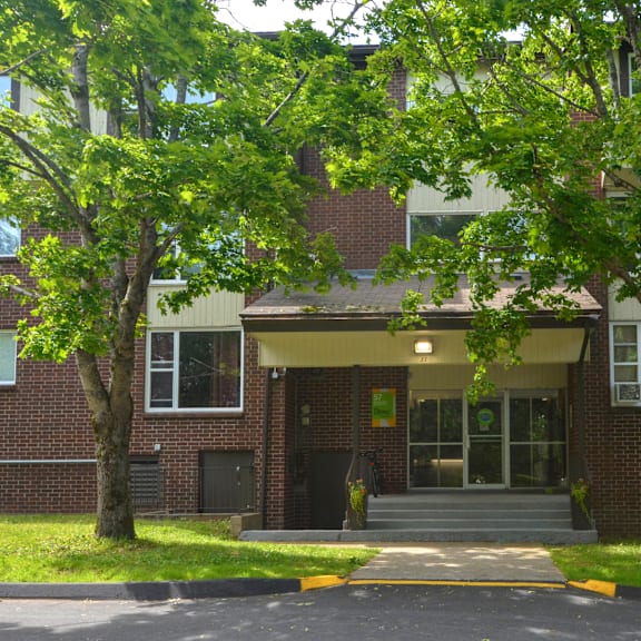 a building with a brick facade and a covered entrance.