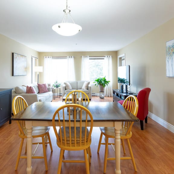 a dining room with a wooden table and chairs.