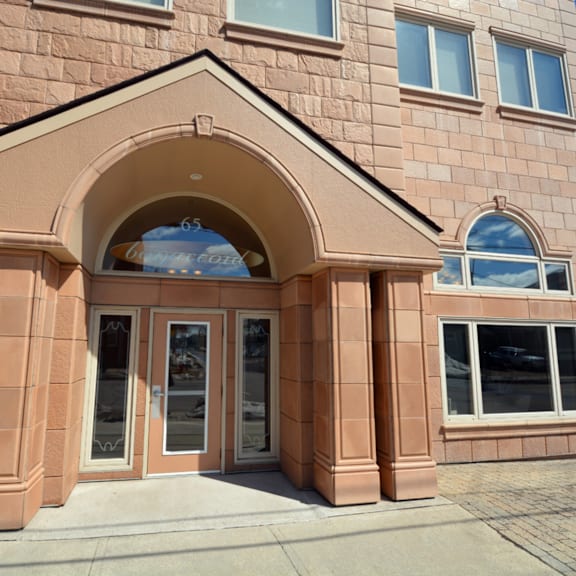 a building with a brown facade and a large arched entrance.