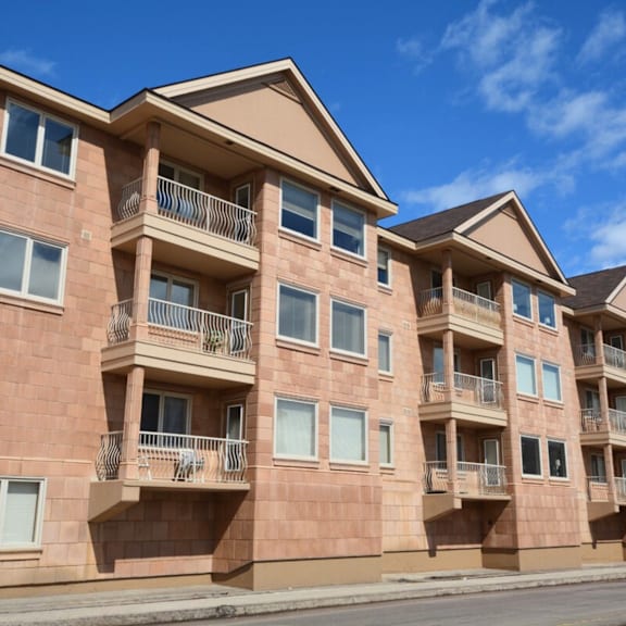 a row of apartment buildings with balconies and windows.