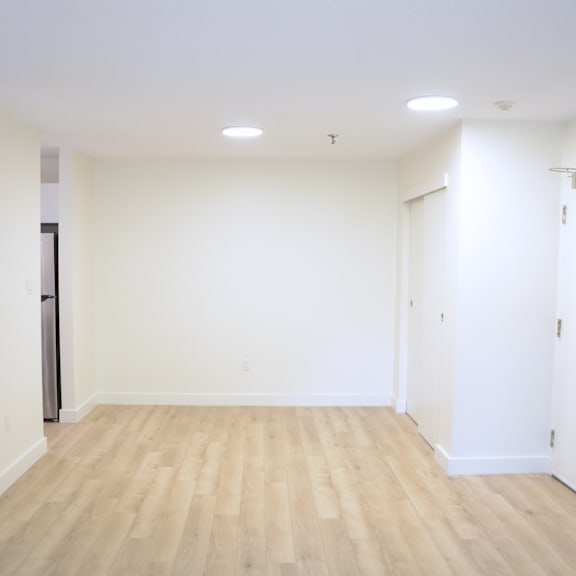 a room with wooden flooring and white walls.