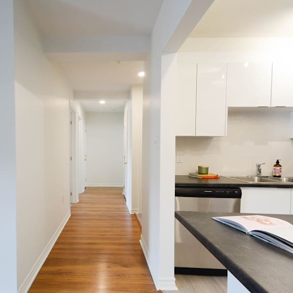 a kitchen with white cabinets and a black countertop.