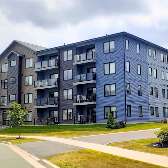 a large apartment building with balconies and multiple windows.