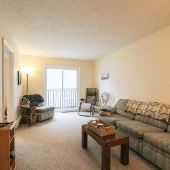a living room with a couch, chair, and table.