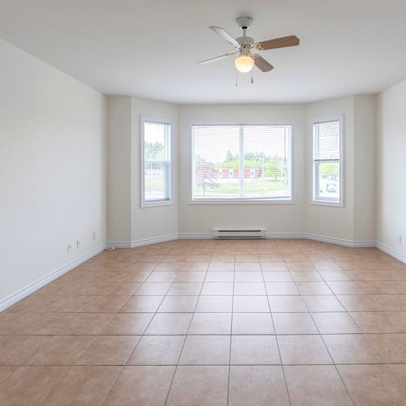 empty room with a ceiling fan and tiled floor.