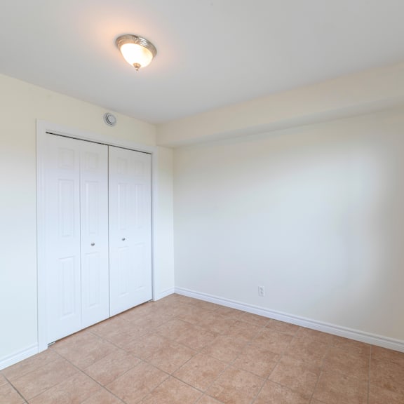 a room with a white door and a brown floor.