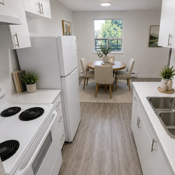 a kitchen with white appliances and a dining table with chairs.