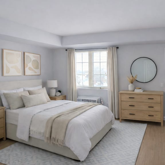 a bedroom with a large bed, two nightstands, and a round mirror on the wall.