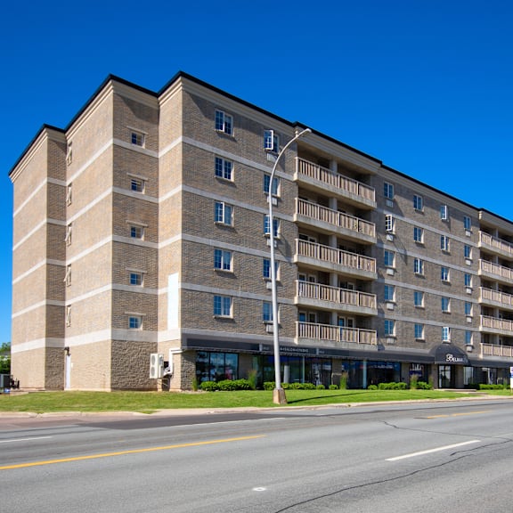 a large apartment building with a balcony on the second floor.