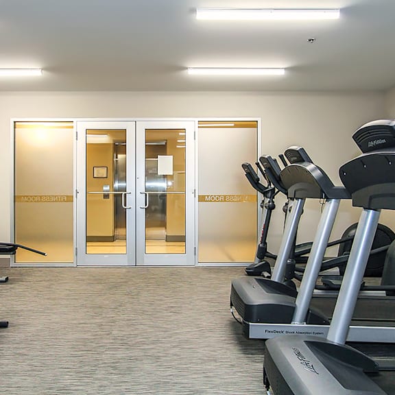 a gym with treadmills and a sign that says "moonwalk".