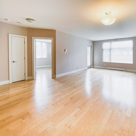 a room with wooden floors and white walls.