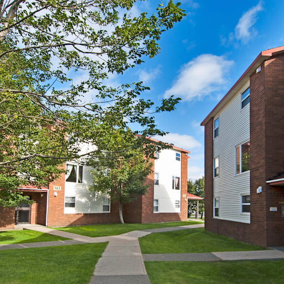 a building with a red brick exterior and a white door.