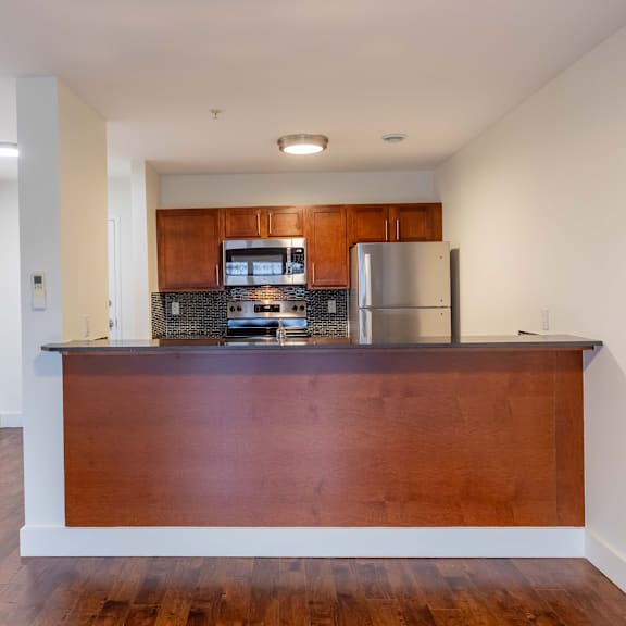 a kitchen with a wooden counter and stainless steel appliances.