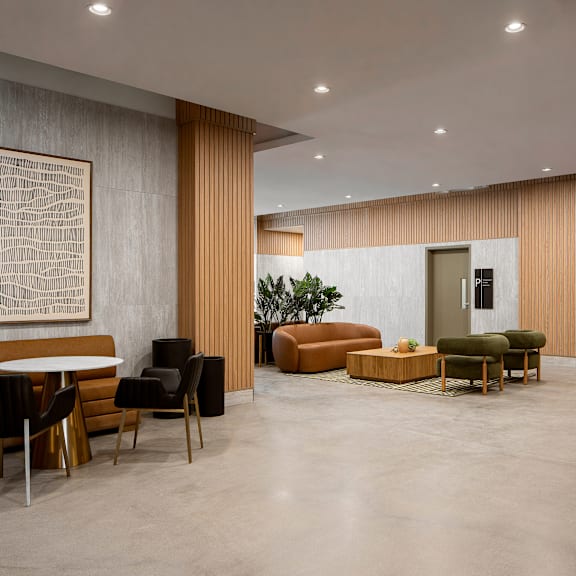 a modern living room with a large abstract painting on the wall and a variety of seating options.