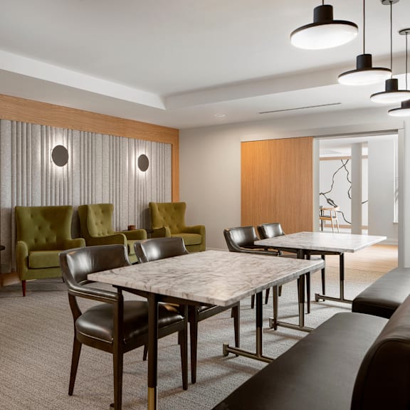 a modern dining room with a large table and chairs.
