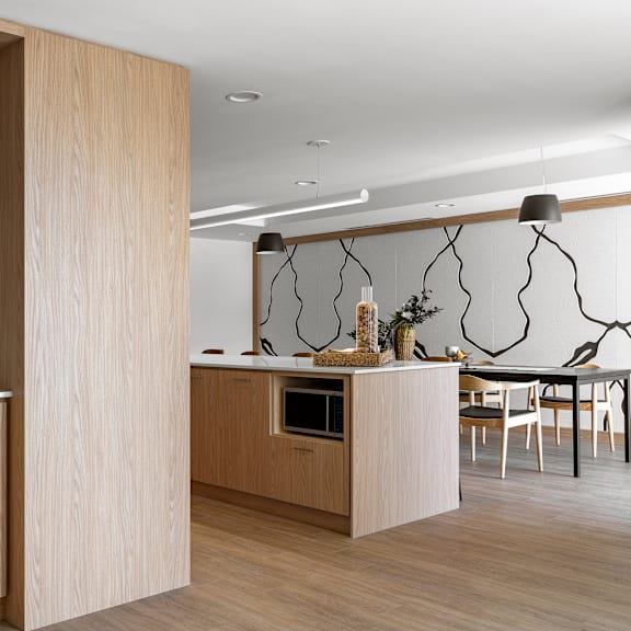 a modern kitchen with wooden cabinets and a central island.