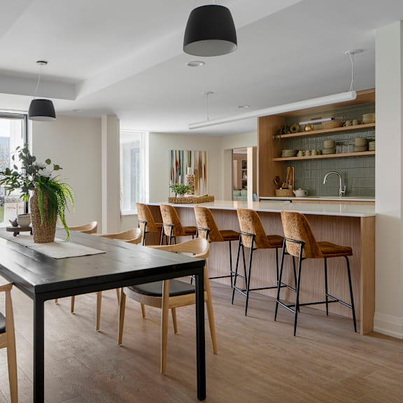 a modern kitchen with a dining table and chairs.