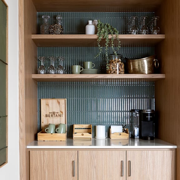 a kitchen shelf with a variety of items including a sign that says "bertant".