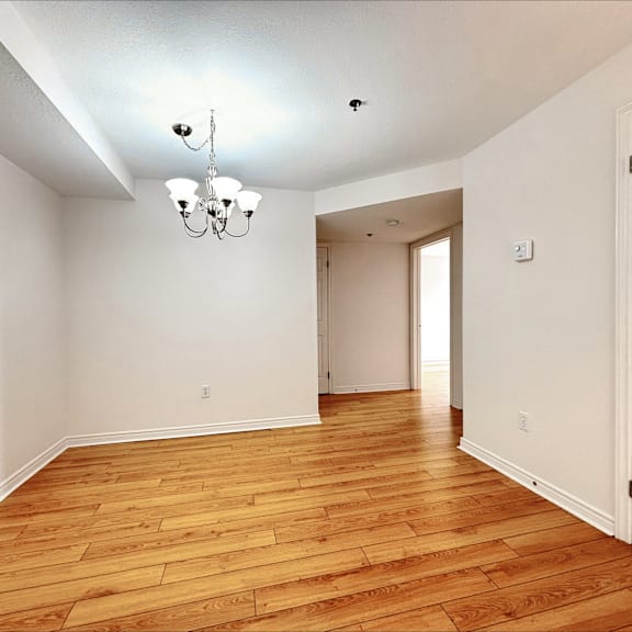 a room with wooden floors and a chandelier.