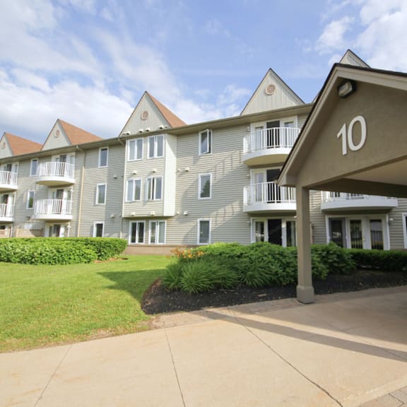 apartment building number 10 with a green lawn in front.