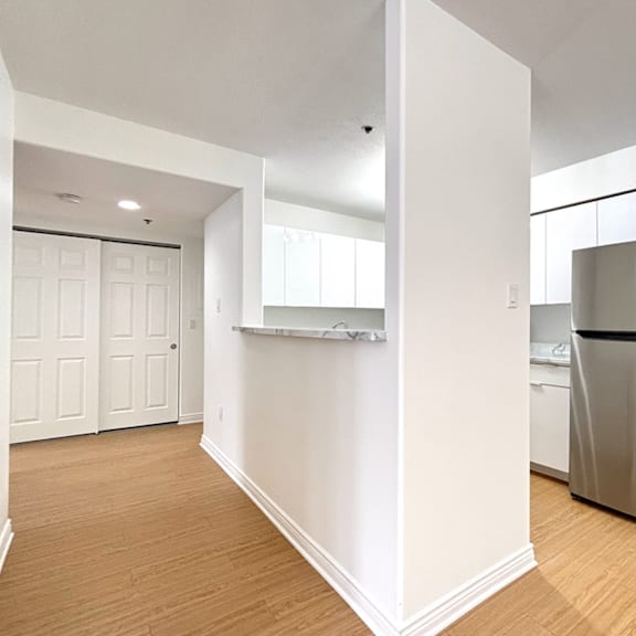 a kitchen with a refrigerator and a countertop.