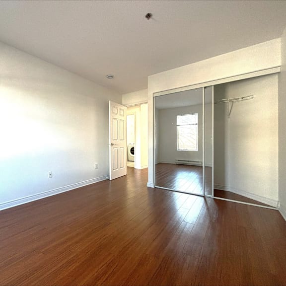 a room with wooden floors and white walls.