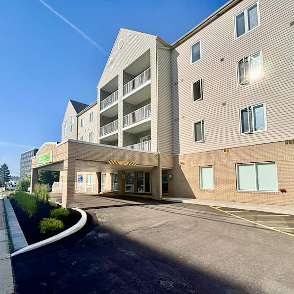 a modern building with a parking lot in front.